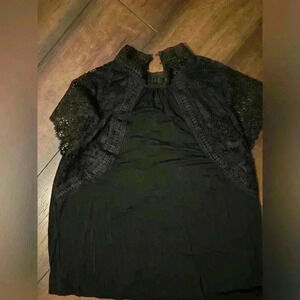 Women’s black short sleeve blouse with lace sleeves. 2 buttons on back of neck